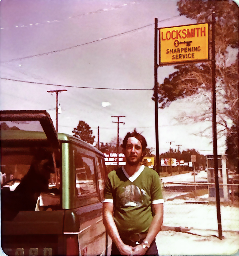jeff standing in front of yellow locksmith sign