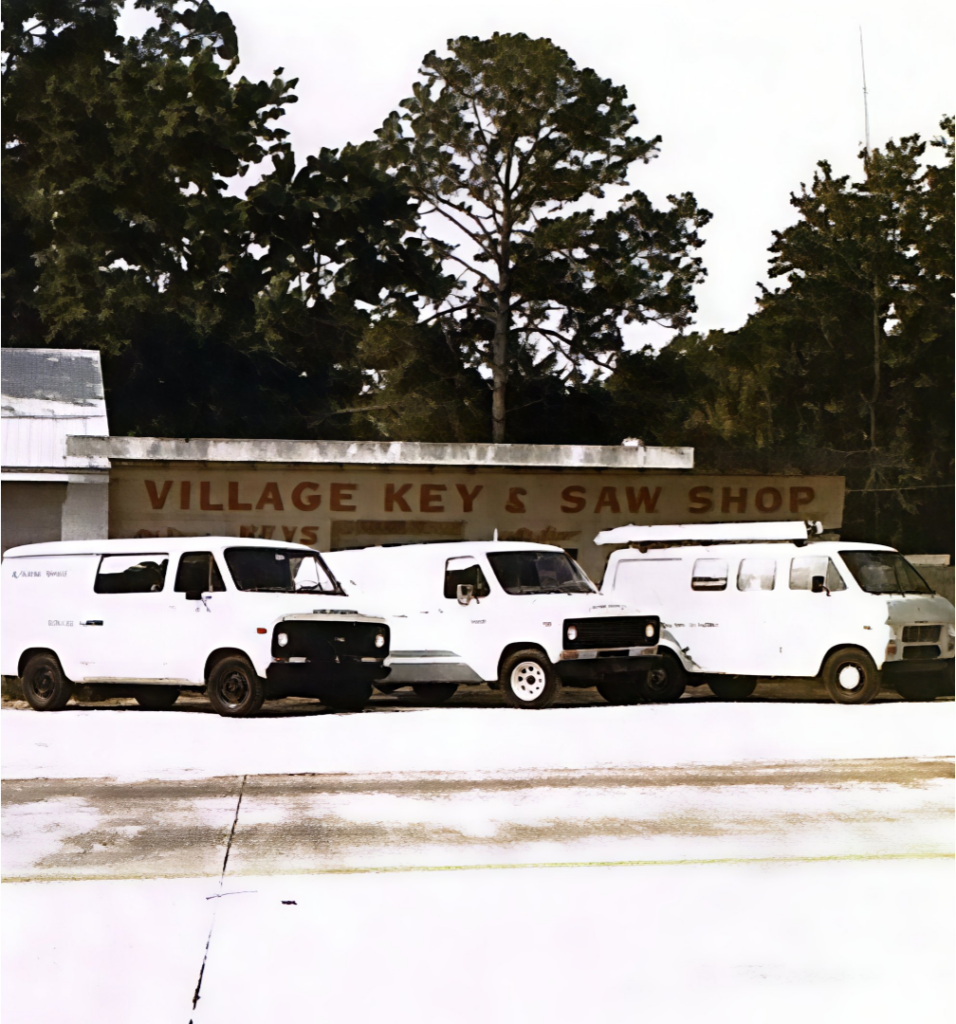 building with 3 service vans in front
